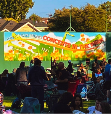 Image of concerts in the park sign hung on tennis court wall at San Bruno City Park